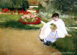 Vrouw en kind zittend in een tuin Vrouw en kind zittend in een tuin